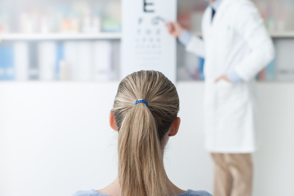 Young,Woman,In,The,Optometrist,Office,Examining,Her,Eyesight,,He